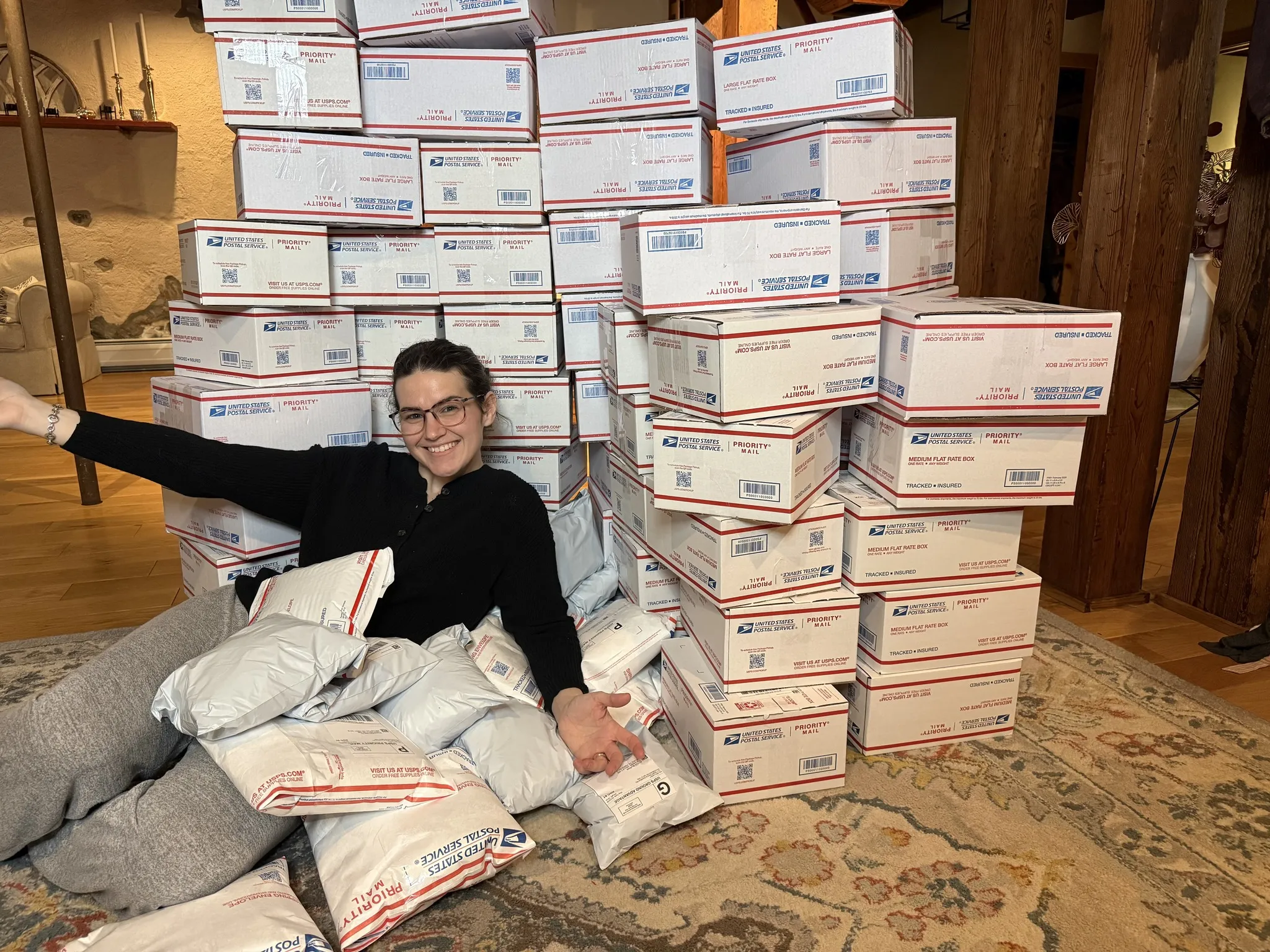 Stacks of USPS packages ready to ship after a live stream
